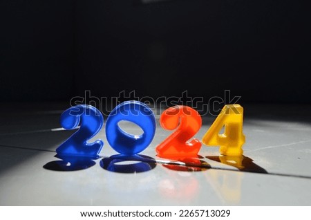 Miniature numbers are arranged in such a way as to form the number 2024. new year 2024 writing. 2024 number arrangement with various colors. 