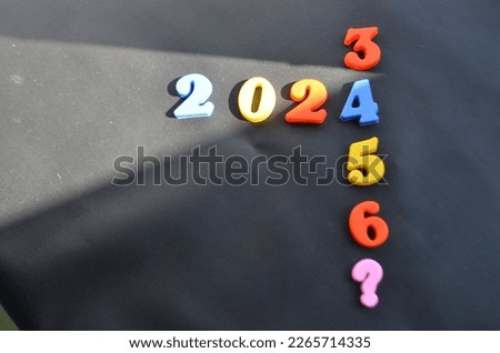 Miniature numbers are arranged in such a way as to form the number 2023. new year 2023 writing. 2023 number arrangement with various colors. 