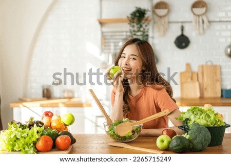 Portrait of beauty body slim healthy asian woman having fun cooking and preparing cooking vegan food healthy eat with fresh vegetable salad in kitchen at home.Diet concept.Fitness and healthy food Royalty-Free Stock Photo #2265715249