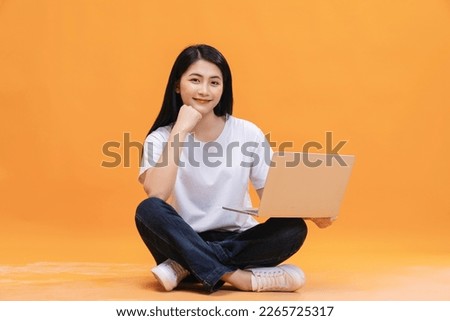 Young Asian girl using laptop on back ground