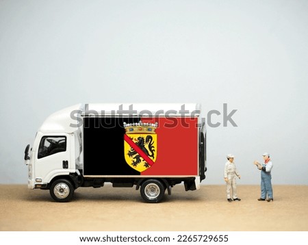 Mini toy at table with white background. Industrial shipping concept. Namur flag design, is a province of Wallonia, one of the three regions of Belgium.