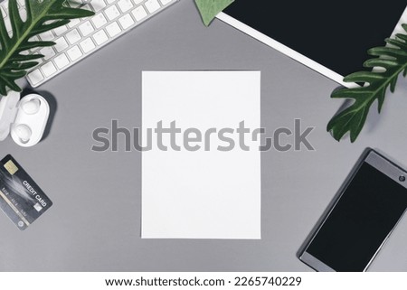 Top view of office table with technology gadget. Mockup blank white paper for advertise copy space. Modern lifestyles with internet flat lay angle  concept.