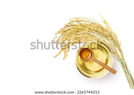 Rice bran oil extract with paddy unmilled rice isolated on white background. Top view. Flat lay. Royalty-Free Stock Photo #2265744213
