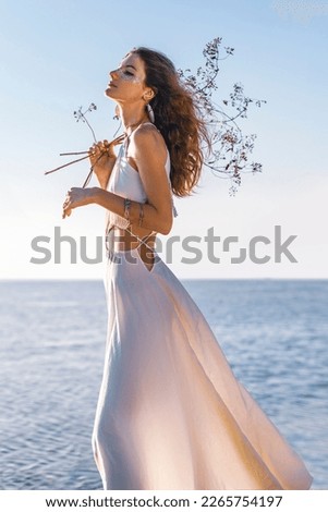 beautiful young stylish woman on the beach