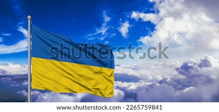 Ukraine national flag cloth fabric waving on beautiful blue sky.