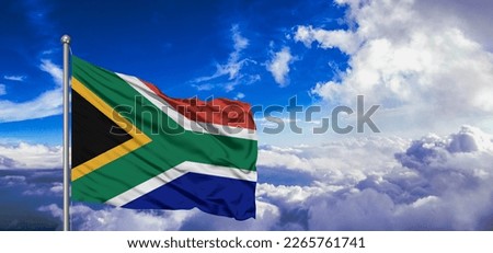 South Africa national flag cloth fabric waving on beautiful blue sky.