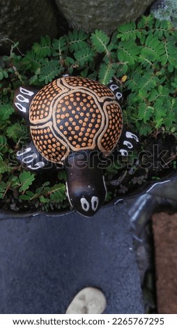 turtle statue on top of a potted plant