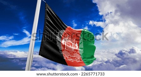 Afghanistan national flag cloth fabric waving on beautiful blue sky.