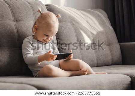 infant  watching cartoons on the phone
