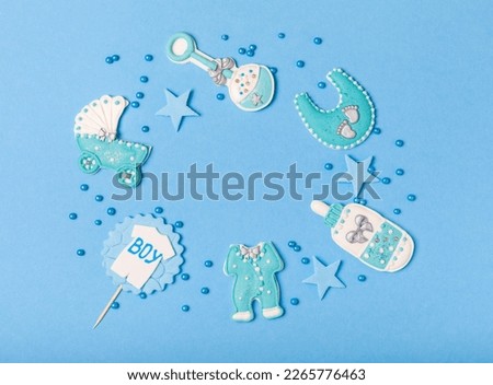 THIS IS A BOY! Baby shower cookies on a bright blue background. Gender cookies. Candy bar holiday baby shower party. Gender party. Holiday concept.