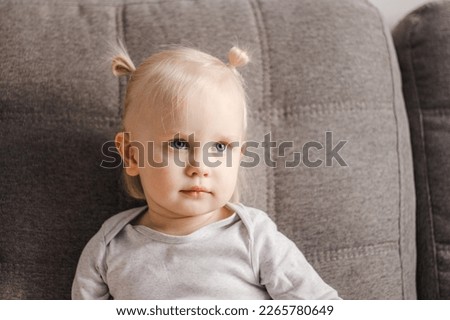 Portrait of a child on the couch.