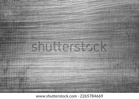 Monochrome texture of shiny scratched metal. Abstract background for design.