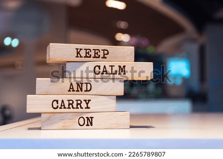 Wooden blocks with words 'Keep calm and carry on'.