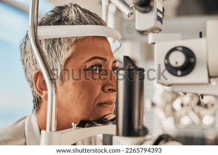 Optometry, slit lamp and eye exam by senior woman or patient with medical insurance using machine. Ophthalmology, eyesight and female test vision in clinic as eyecare during consultation Royalty-Free Stock Photo #2265794393