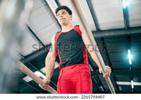 Gymnastics, fitness and man training in a studio for a competition, performance or show. Sports, athlete and male gymnast practicing for flexibility, agility or strength for balance at event in arena
