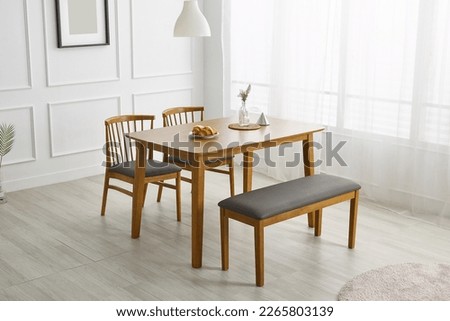Wood dining table landscape with sunlight. Royalty-Free Stock Photo #2265803139