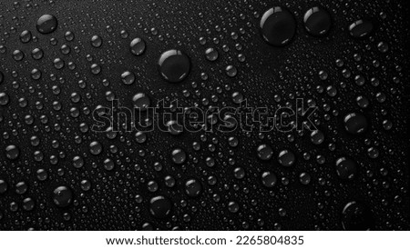 Water drops on a black background. Banner with raindrops. Top view. Royalty-Free Stock Photo #2265804835