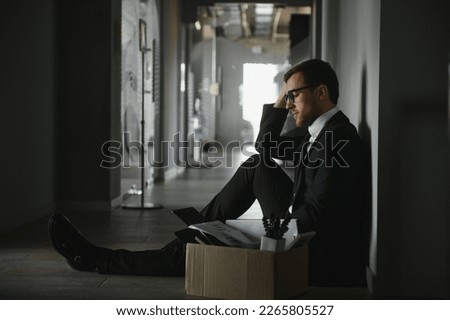 Sad Fired. Let Go Office Worker Packs His Belongings into Cardboard Box and Leaves Office. Workforce Reduction, Downsizing, Reorganization, Restructuring, Outsourcing. Mass Unemployment Market Crisis. Royalty-Free Stock Photo #2265805527