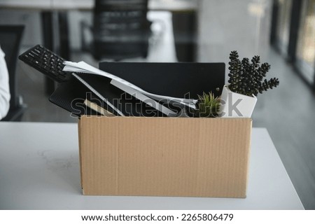 Close-up Of A Businessperson Carrying Cardboard Box During Office Meeting.