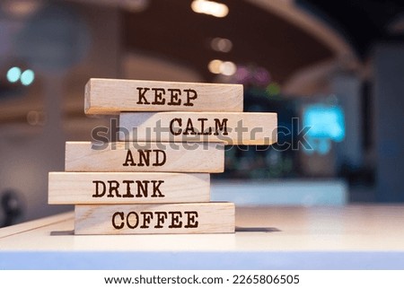 Wooden blocks with words 'Keep Calm And Drink Coffee'.