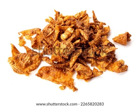 Crispy fried chicken skin on white background, snack food.