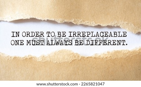 In order to be irreplaceable one must always be different. Words written under torn paper. Motivation concept text. Royalty-Free Stock Photo #2265821047