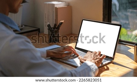 Businessman checking news, typing email on laptop computer. Over shoulder view.	 Royalty-Free Stock Photo #2265823051