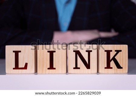 The word "Link" written on wood cube.