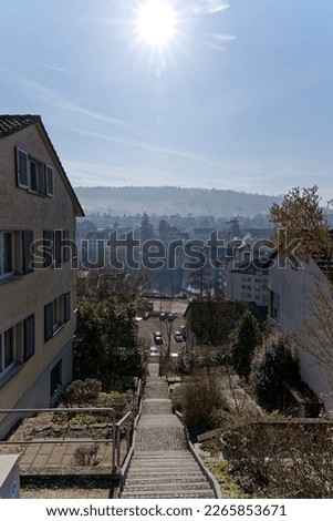 Aerial view over City of Schaffhausen on a sunny winter day with local mountain Cholfirst in the background. Photo taken February 16th, 2023, Schaffhausen, Switzerland.