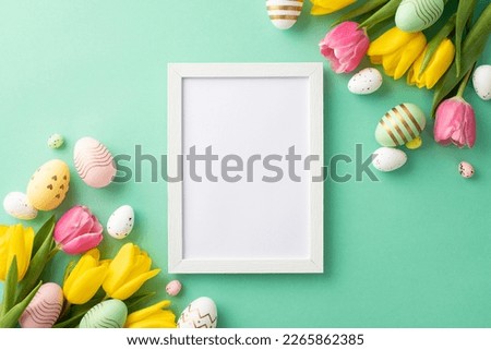 Easter celebration concept. Top view photo of white photo frame colorful easter eggs and bunches of tulips on isolated teal background with blank space