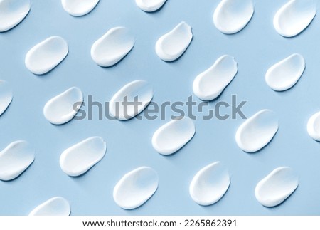 pattern cosmetic smears cream texture on pastel blue background