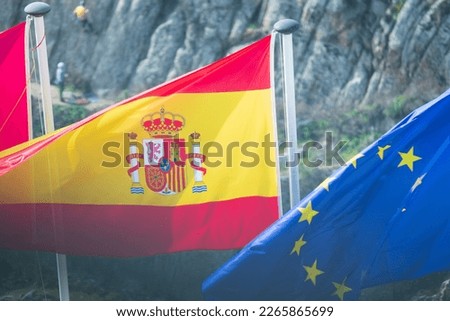 Spanish flag waving next to the Eu flag in Toledo, Spain