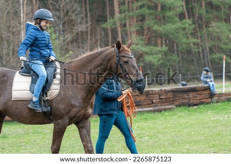 A girl in a helmet on a horse ride