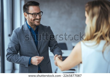 Sealing a deal! Two Business people shaking hands after Welcoming partners finishing up a meeting or setting goals and planning way to success in the office. 