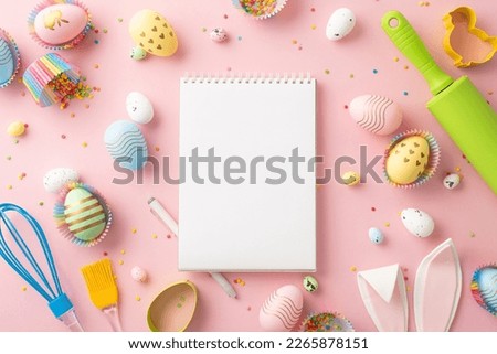 Easter concept. Top view photo of book of recipes kitchen utensils colorful easter eggs in paper baking molds easter bunny ears and sprinkles on isolated pastel pink background with blank space