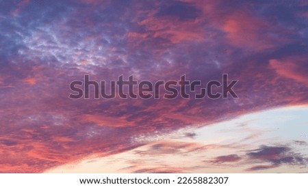 Sunset sky. Cirrocumulus and cirrostratus clouds during sunset. Beautiful dramatic sunset sky background. Selective focus included. Noisy photo Royalty-Free Stock Photo #2265882307