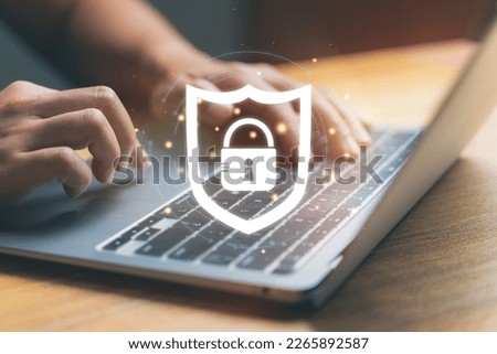 Close up hand using laptop with security lock icon. Social internet security, online privacy concept. Royalty-Free Stock Photo #2265892587