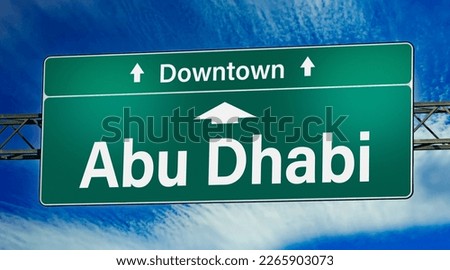Road sign indicating direction to the city of Abu Dhabi.
