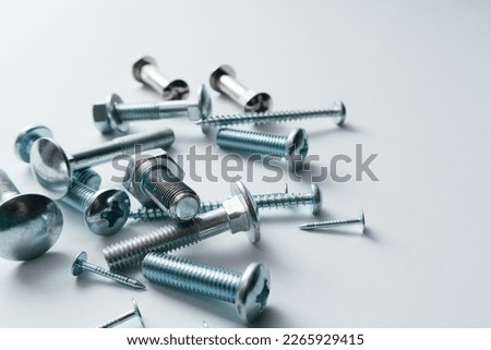 Set of bolts, screws, nails. Construction abstraction. Industrial background. Screws and bolts macro photo, white background, steel screw, bolt macro.