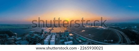 Solar Farm (solar cell) at sunset sky background. Renewable green alternative energy. Power plant. Solar photovoltaic rows array of ground mount system Installation.