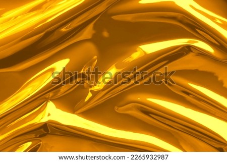 Shiny crumpled golden foil as background, closeup