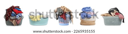 Set with different laundry baskets full of clothes on white background Royalty-Free Stock Photo #2265935155
