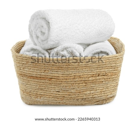 Wicker laundry basket with clean towels isolated on white Royalty-Free Stock Photo #2265940313