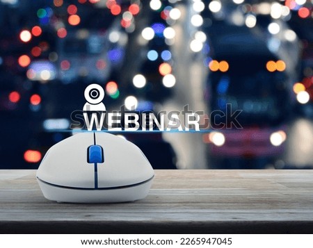 Webinar flat icon with wireless computer mouse on wooden table over blur colorful night light traffic jam road in city, Business seminar online concept