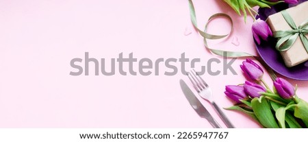 festive table setting with a purple plate and tulips on a pink background. valentine's day, mother's day, women's day 8 march concept. flat lay. copy space. top view. Royalty-Free Stock Photo #2265947767