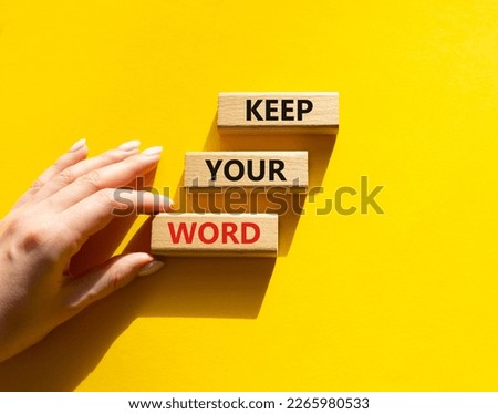 Keep your word symbol. Wooden blocks with words Keep your word. Beautiful yellow background. Businessman hand. Business and Keep your word concept. Copy space.