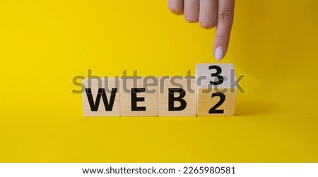 Web 3 vs Web 2 symbol. Businessman Hand points at turned wooden cubes with words web 2 vs web 3. Beautiful yellow background. Business concept. Copy space
