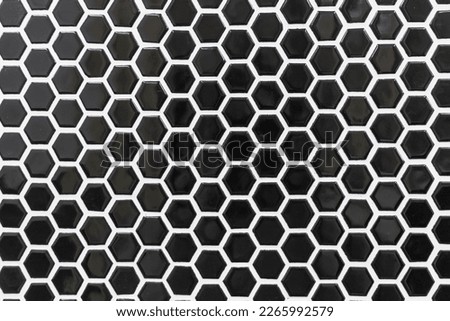 Black octagon tile with white grout in a backsplash, shower, bathroom wall area. Royalty-Free Stock Photo #2265992579