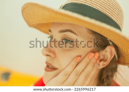 A girl in a hat and a pensive look