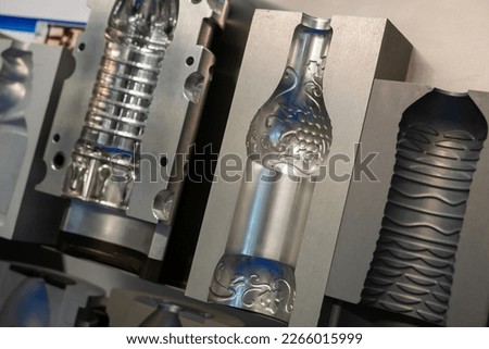Mold plates for plastic bottles production - part of automatic injection molding machine at exhibition, trade show - close up. Manufacturing, technology concept Royalty-Free Stock Photo #2266015999
